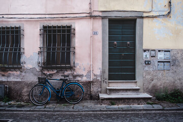 old bicycle in front of a house in Lucca, Italy