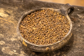 Pepper in a wooden bowl.