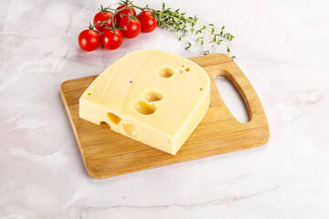 Maasdam cheese brick over board