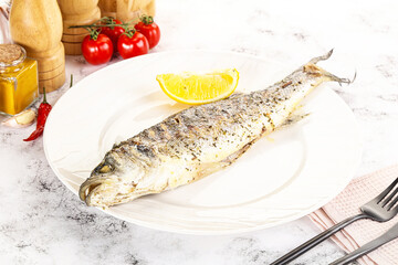 Grilled sea bass fish served lemon