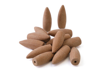 Pile of sandalwood backflow incense cones, isolated on white background.