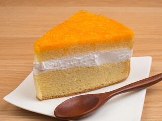 Orange cake in plate on wood table background