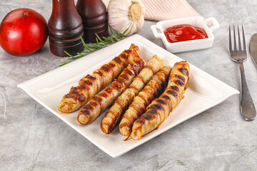 Grilled meat sausages wrapped bacon
