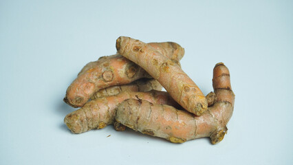 Fresh whole turmeric isolated on white background.