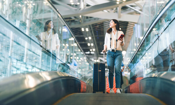 Portrait of standing tourist woman passenger at international airport terminal for holidays travel