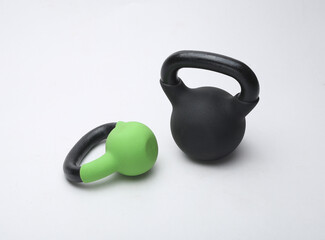 colorful kettlebell weights isolated on light background