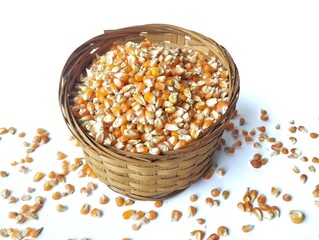 Dry grain corn in basket isolated on white background 