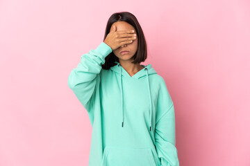 Young latin woman isolated on pink background covering eyes by hands. Do not want to see something