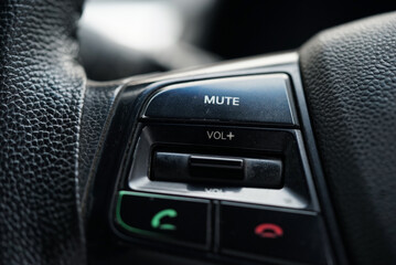 Closeup image of car steering wheel with calling function buttons