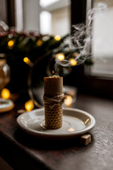 christmas candles in the shape of a burning candle on a white plate