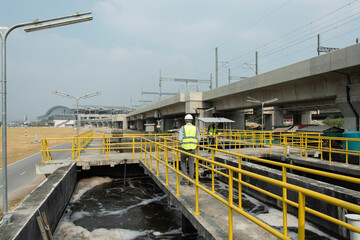 Wastewater treatment concept. Service engineer on  waste water Treatment plant and checking oxygen in water with tablet.  Wastewater treatment concept. Service engineer on waste water Treatment plant.