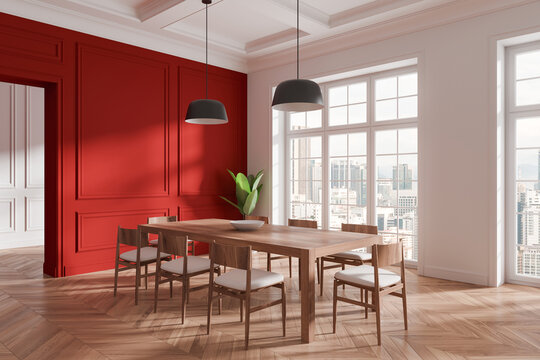 Elegant dining room with wooden table, chairs, red accent wall, large windows, and city view. Modern design concept. 3D Rendering