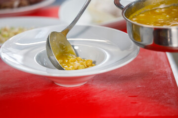 Chef is serving some white beans in a plate