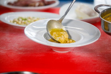 Chef is serving some white beans in a plate