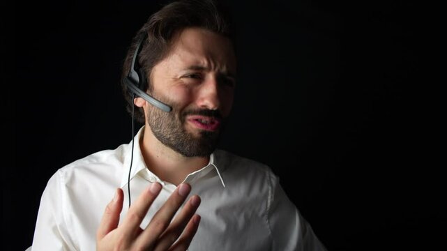 Kind customer service, man wearing white shirt is talking with customer using headset