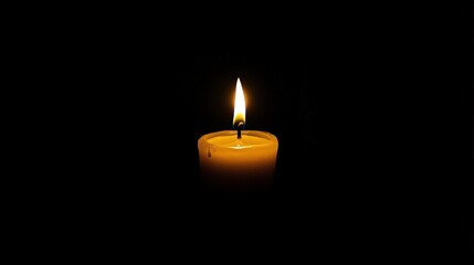 A single candle glowing brightly in darkness, representing warmth and tranquility.