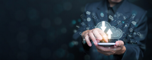 Cloud computing concept. A businessman using cloud computing service through a smartphone to enable...