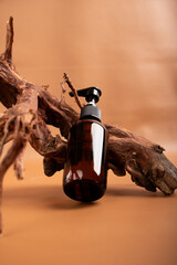 Amber Glass Pump Bottle with Rustic Driftwood on Warm Background