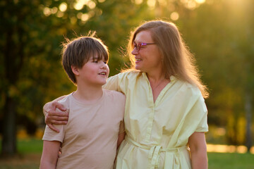 The close relationship between the mother and her boy is evident as they laugh together under the...