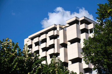Building with square pattern standing tall in the sky