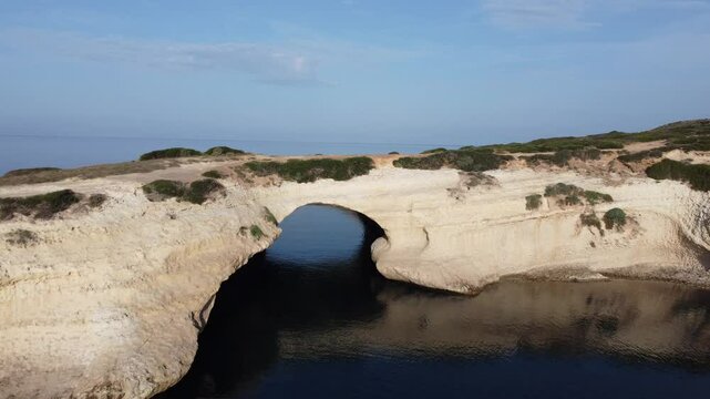 aerial view of the rock of S'Archittu di Santa Caterina in the province of Oristano, Sardinia, Italy