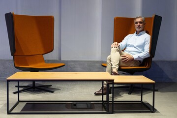 Handsome businessman looking seriously in the office lounge.