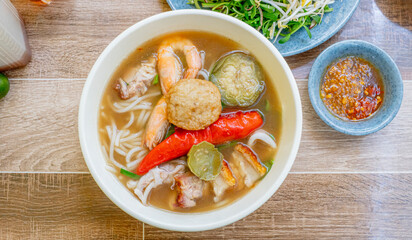 Bun Mam noodles soup. Popular Vietnam seafood noodles soup - Bun Mam noodles. Bowl of delicious Vietnamese seafood noodles soup served with vegetables