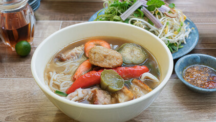 Bun Mam noodles soup. Popular Vietnam seafood noodles soup - Bun Mam noodles. Bowl of delicious Vietnamese seafood noodles soup served with vegetables
