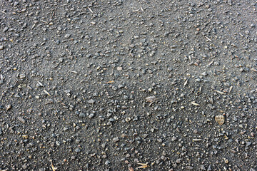 Asphalt texture background with small pebbles covered with frost