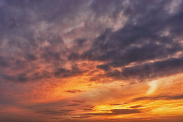 Obraz premium Sunset sky with bright orange and purple hues in a tranquil landscape at dusk