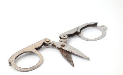 Partially opened scissors showing a view of the blades and handles on a white background.