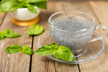 Basil seeds on textured wooden background. Close-up. Superfood. Ocimum basilicum. Organic basil seeds. selasih. Space for text. Copy space.