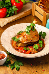 The dish is stewed beef shank with vegetables, beautifully served in a cafe, restaurant, rustic.