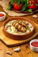 Dish - chicken shashlik in sauce with mushrooms, beautiful presentation in a cafe, restaurant, rustic.