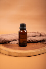 Amber Glass Bottle with Candle and Dried Flowers on Wooden Tray for Spa and Aromatherapy
