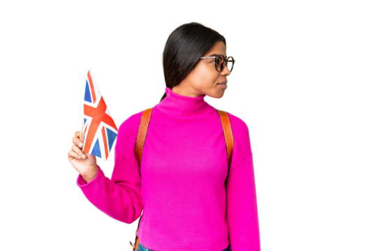 Young African American woman holding an United Kingdom flag over isolated chroma key background looking to the side