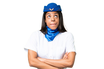 Airplane stewardess African american woman over isolated background making doubts gesture while lifting the shoulders
