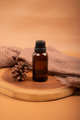Amber Glass Bottle with Candle and Dried Flowers on Wooden Tray for Spa and Aromatherapy