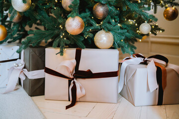 Beautifully wrapped gifts beneath a decorated Christmas tree at home