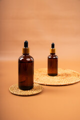 Amber Glass Dropper Bottles on Woven Mats for Natural Skincare and Essential Oils