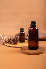 Amber Glass Essential Oil Bottle with Candles and Diffuser on Woven Mat for Spa and Relaxation