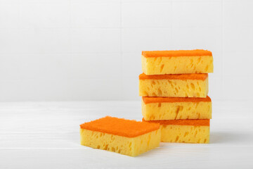 Colorful dish sponges on textured background. Kitchen sponge. Cleaning concept, cleaning service. Dishwashing liquid with clean and dirty dishes plate. Place for text, copy space. Wash the dishes.