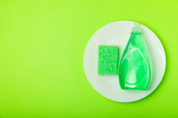 Colorful dish sponges on textured background. Kitchen sponge. Cleaning concept, cleaning service. Dishwashing liquid with clean and dirty dishes plate. Place for text, copy space. Wash the dishes.