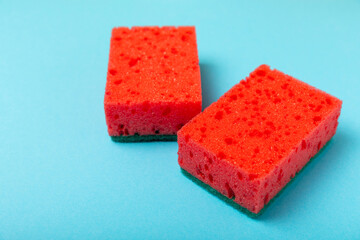 Colorful dish sponges on textured background. Kitchen sponge. Cleaning concept, cleaning service. Dishwashing liquid with clean and dirty dishes plate. Place for text, copy space. Wash the dishes.