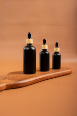 Black Dropper Bottle with Cinnamon Sticks and Tealight Candles for Cozy Aromatherapy Decor
