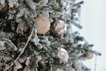 Decorated Christmas tree adorned with ornaments and lights in a cozy setting