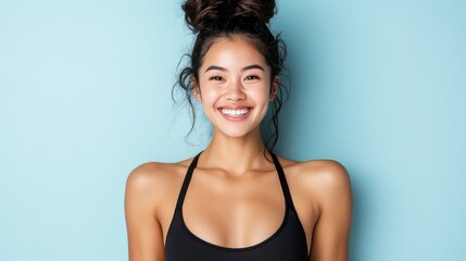 Fototapeta premium A radiant young woman in activewear beams confidently against a vibrant backdrop, embodying health, positivity, and a zest for life.