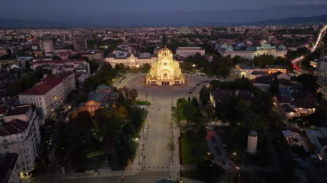 4K aerial night view of Bulgaria's capital Sofia. Iconic building. View of the Cathedral of St. Alexander Nevsky at nightfall, the largest church in the Balkans. Lateral movement. Streets and parks