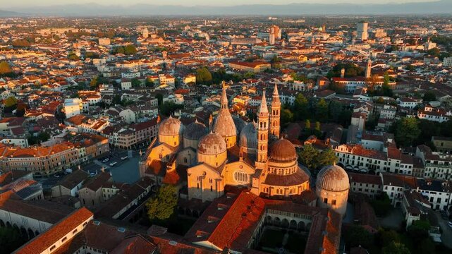 Renaissance architecture in Italy, flying above Padova cathedral at sunrise, drone view of Basilica of Saint Anthony of Padua in morning light