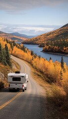 White RV on a Scenic Autumn Road Trip Through Vibrant Mountain Landscape with Lake Views
